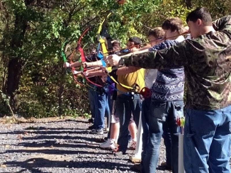 A group of McDowell Choices kids practice archery skills.