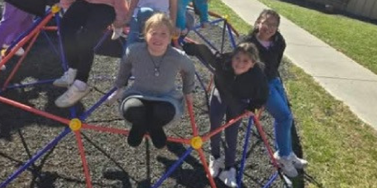 group of kids climbing on playground equipment