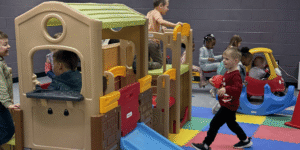 kids playing indoors on play equipment