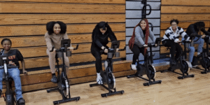 a row of kids on stationary bikes