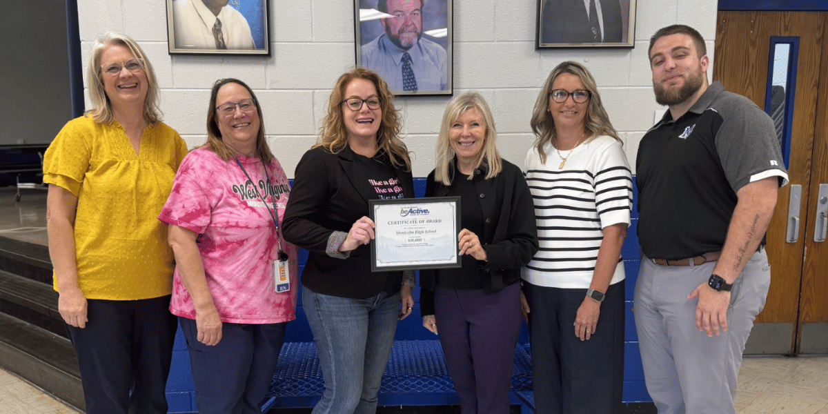 the wv be active team presenting a certificate for the grant money